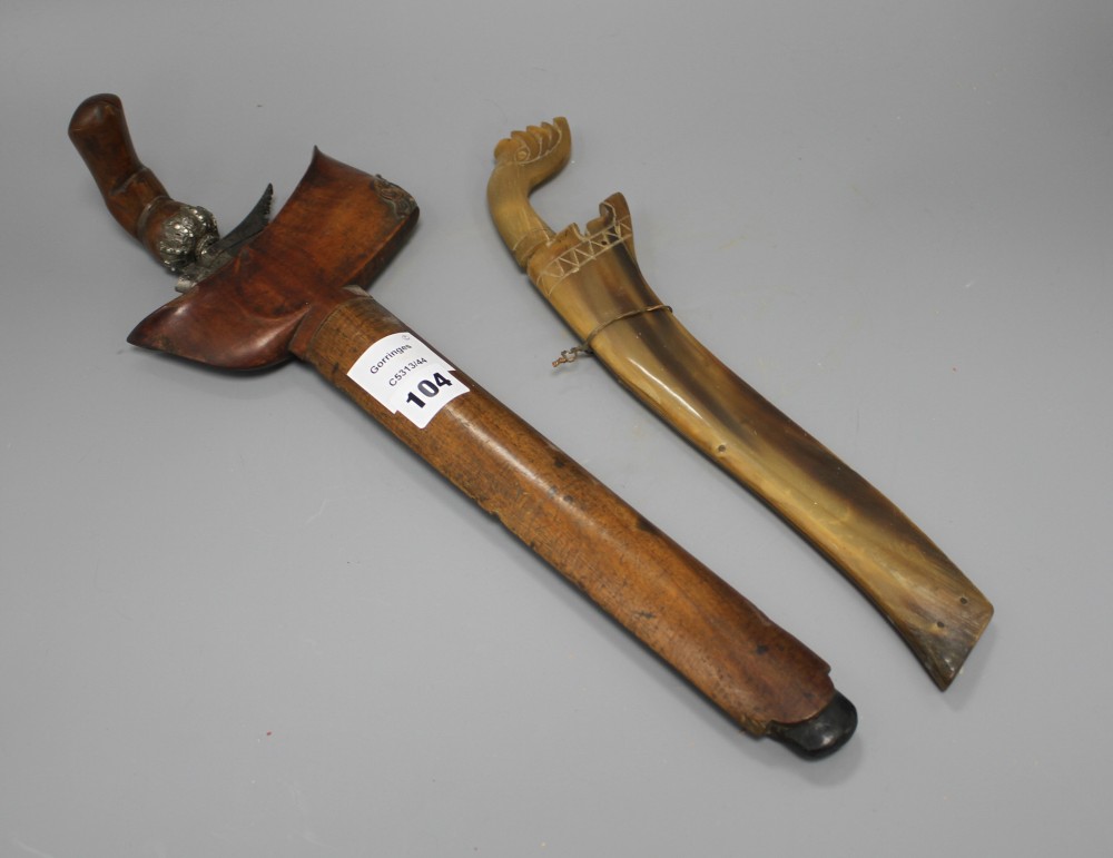 A Kris with hardwood handle and scabbard and another similar with horn scabbard